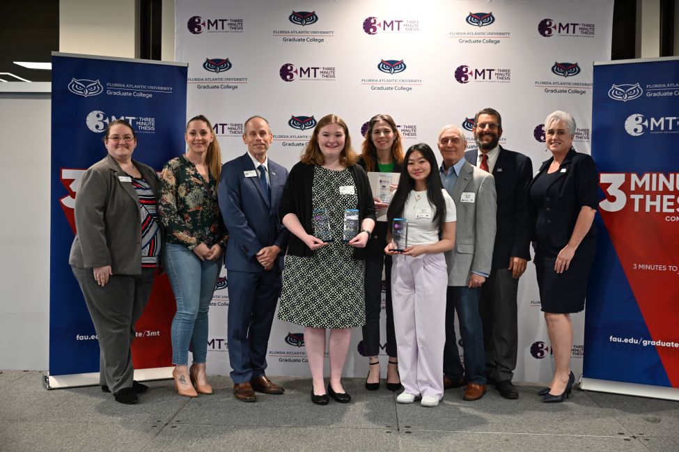Winners of MŮ's eighth annual Three Minute Thesis (3MT®) Competition along with attending dignitaries